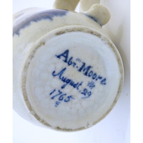 123 - A late 19th / early 20thC French copy of an Abraham Moore Lowestoft blue and white mug with floral d... 