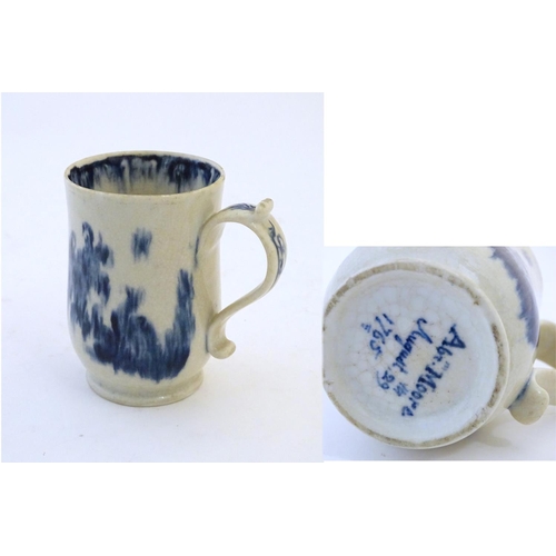 123 - A late 19th / early 20thC French copy of an Abraham Moore Lowestoft blue and white mug with floral d... 