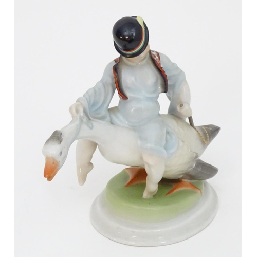 125 - A Herend pottery model of Ludas Matyia / Mattie the Goose-Boy, depicting a young boy riding a goose.... 