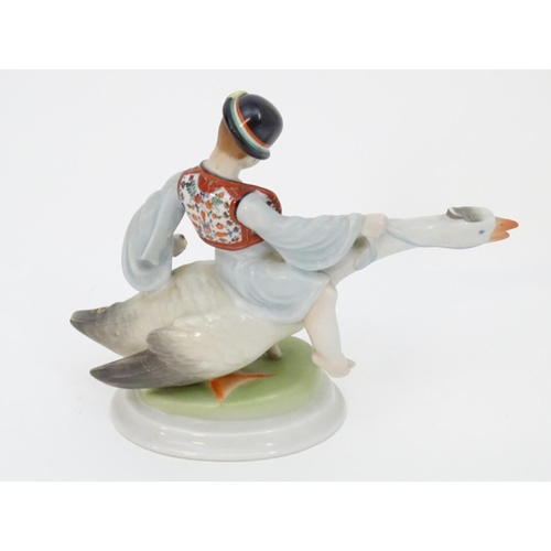 125 - A Herend pottery model of Ludas Matyia / Mattie the Goose-Boy, depicting a young boy riding a goose.... 