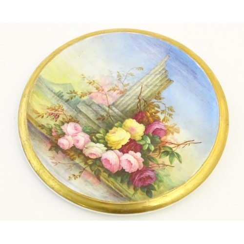 143 - A 19thC roundel in the manner of Derby with hand painted decoration depicting an Italian landscape s... 