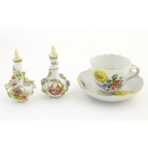 100 - A pair of Continental vases with relief floral decoration. Together with a tea cup and saucer with f... 