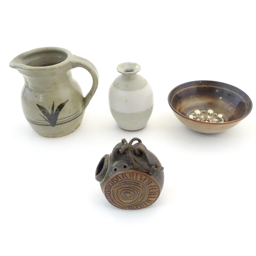 107 - Four assorted studio pottery wares comprising a flask with relief roundel and laced detail by Tremar... 