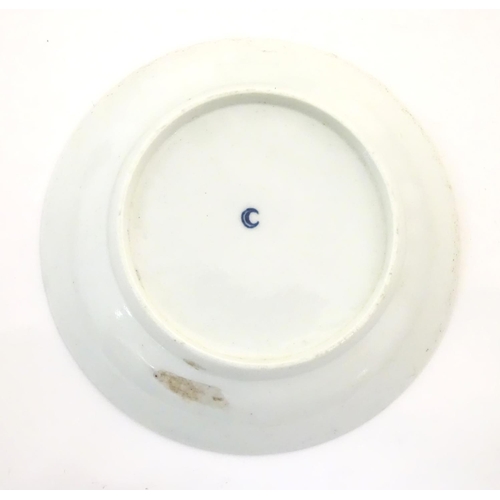 119 - A Royal Worcester blue and white saucer with Oriental landscape detail. Marked with crescent moon un... 