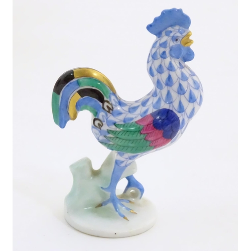 127 - A Herend pottery model of a cockerel with fishnet decoration and gilt highlights. Marked under. Appr... 