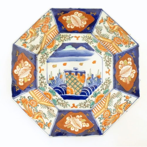 39 - A Japanese octagonal plate in the Imari palette decorated with birds, flowers and foliage, with cent... 