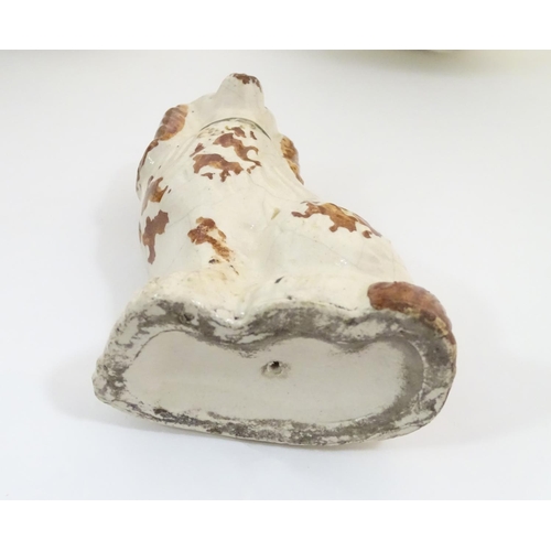 62A - A pair of Staffordshire pottery seated spaniels, together with another smaller example. Largest appr... 