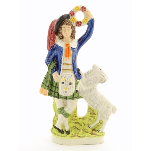 74 - A Staffordshire pottery figure of a Highland man wearing a kilt with a sporran and a plume hat, hold... 