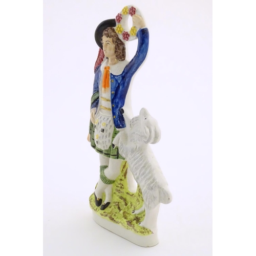 74 - A Staffordshire pottery figure of a Highland man wearing a kilt with a sporran and a plume hat, hold... 