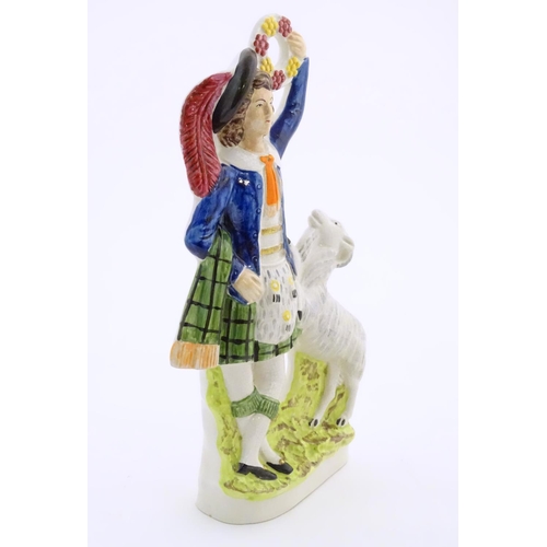 74 - A Staffordshire pottery figure of a Highland man wearing a kilt with a sporran and a plume hat, hold... 