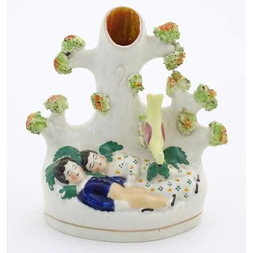 76 - A Staffordshire pottery bud vase with two sleeping children under a tree. Approx. 5 1/4