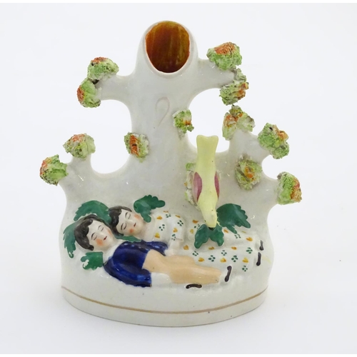 76 - A Staffordshire pottery bud vase with two sleeping children under a tree. Approx. 5 1/4