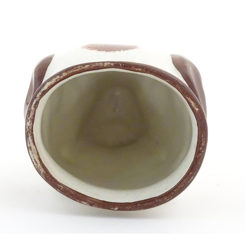 79 - A Victorian Staffordshire pottery stirrup cup formed as the head of a dog / hound. Approx. 4 1/2