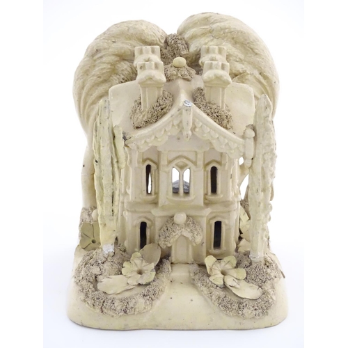 81 - A large Victorian Staffordshire creamware pastille burner modelled as a house and garden with trees.... 