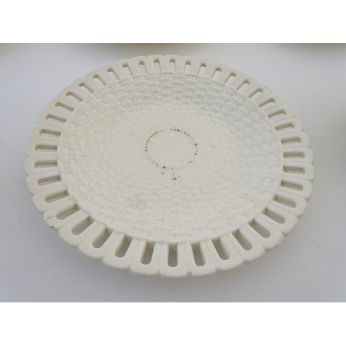 82 - A quantity of Continental creamware chestnut baskets, plates and dishes with reticulated detail. Wit... 