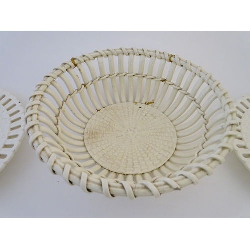 82 - A quantity of Continental creamware chestnut baskets, plates and dishes with reticulated detail. Wit... 