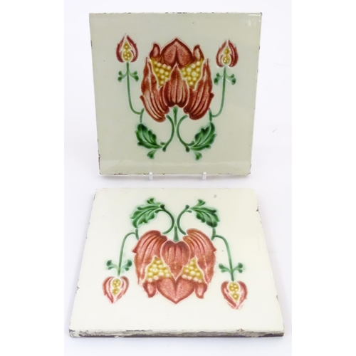 85 - Two tiles decorated with stylised tulip / flower detail. Marked Made in England verso. Approx. 6