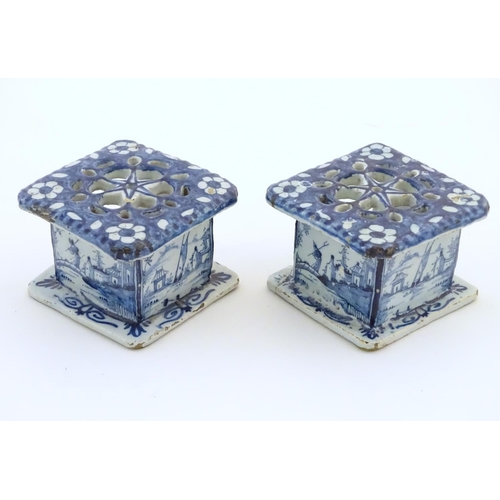 86 - Two Delft blue and white miniature stove / burners of squared form, the three side panels decorated ... 