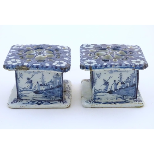 86 - Two Delft blue and white miniature stove / burners of squared form, the three side panels decorated ... 