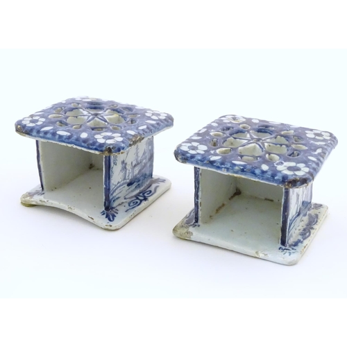 86 - Two Delft blue and white miniature stove / burners of squared form, the three side panels decorated ... 