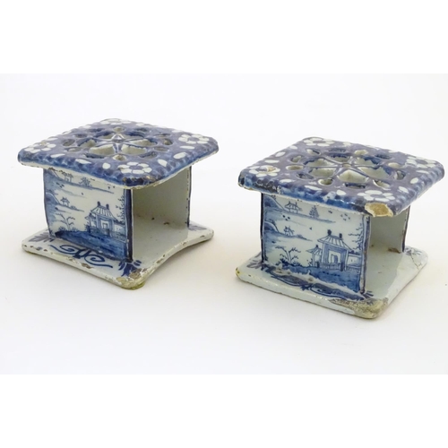 86 - Two Delft blue and white miniature stove / burners of squared form, the three side panels decorated ... 