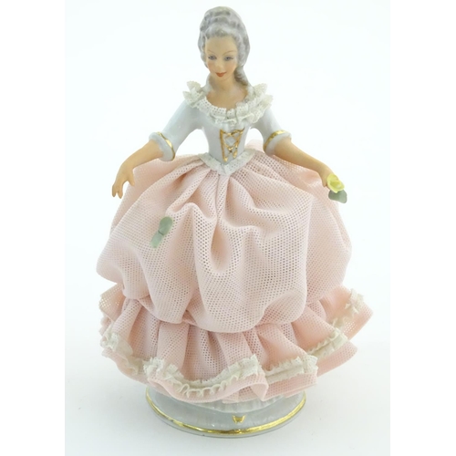 94 - A Dresden model of a lady with a porcelain lace dress. Marked under. Approx. 5 3/4