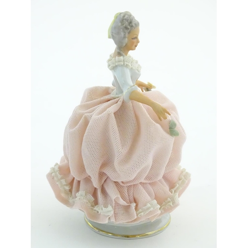 94 - A Dresden model of a lady with a porcelain lace dress. Marked under. Approx. 5 3/4