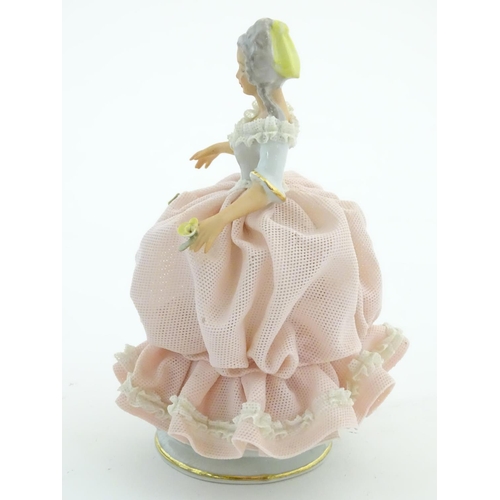 94 - A Dresden model of a lady with a porcelain lace dress. Marked under. Approx. 5 3/4