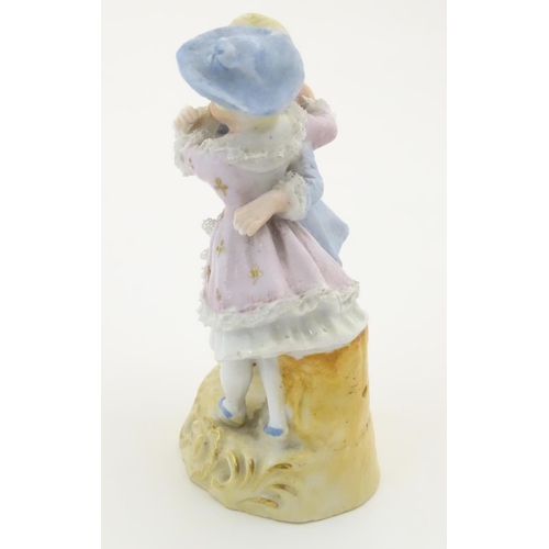 95 - A Continental figural group depicting a man and woman in 18thC dress with porcelain lace detail and ... 