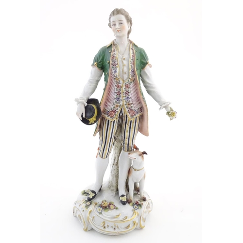 97 - Two German porcelain figures, a model of a young man holding a hat and flower with a dog beside him,... 