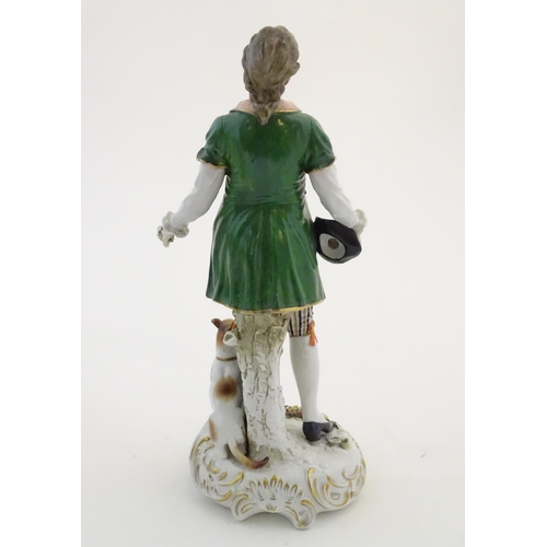 97 - Two German porcelain figures, a model of a young man holding a hat and flower with a dog beside him,... 