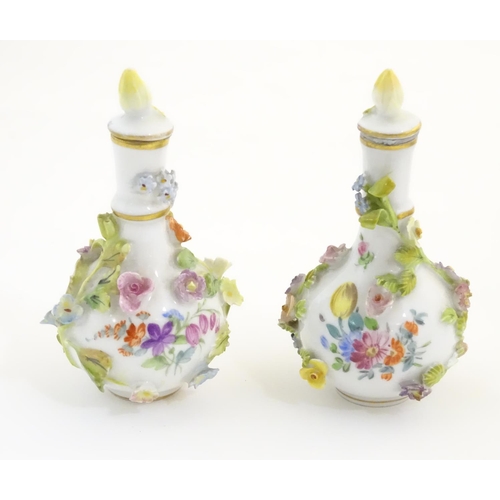 100 - A pair of Continental vases with relief floral decoration. Together with a tea cup and saucer with f... 