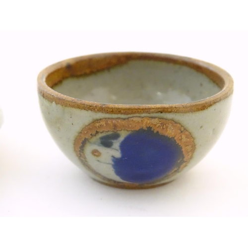 112 - A small saucer with naive hand painted decoration, together with a small tea bowl decorated with the... 