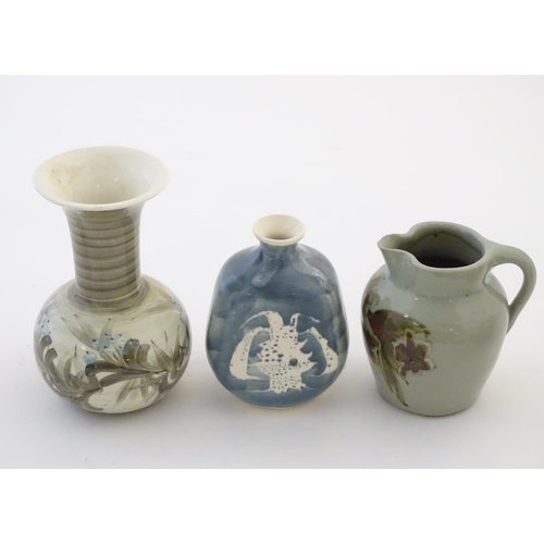 114 - Three studio pottery items comprising a small jug by Caroline Eeles with floral and foliate detail, ... 