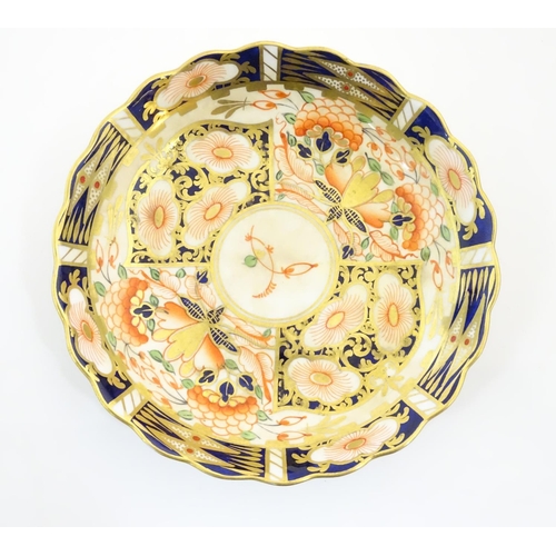 119 - A Royal Worcester blue and white saucer with Oriental landscape detail. Marked with crescent moon un... 