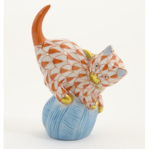 128 - A Herend pottery model of a cat with a ball of string / wool with fishnet decoration and gilt highli... 