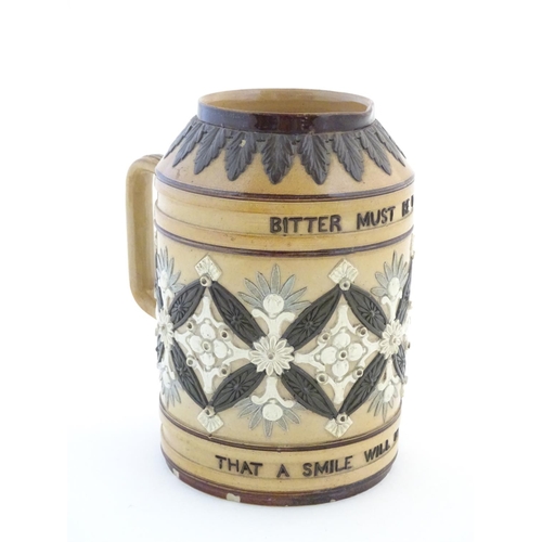 136 - A Doulton Lambeth stoneware verse tankard, with relief foliate detail and the motto Bitter Must Be T... 