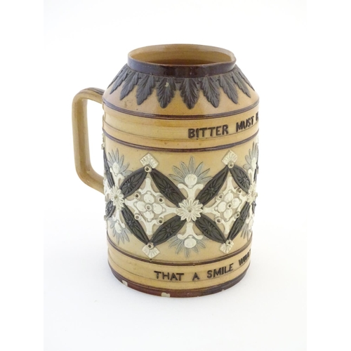 136 - A Doulton Lambeth stoneware verse tankard, with relief foliate detail and the motto Bitter Must Be T... 