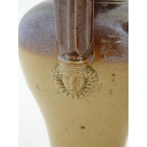 138 - A Doulton Lambeth two tone stoneware jug with relief mask detail to neck. Marked under. Together wit... 