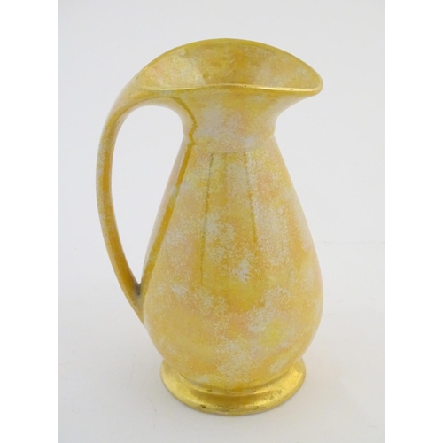 140 - A Govancroft Glasgow pottery jug with yellow spongeware decoration. Approx. 9