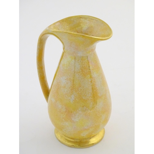 140 - A Govancroft Glasgow pottery jug with yellow spongeware decoration. Approx. 9