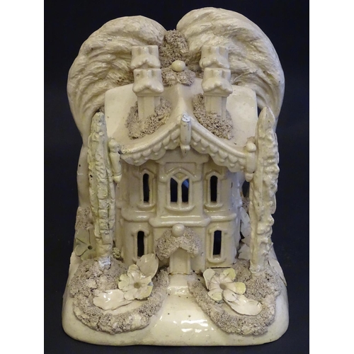 81 - A large Victorian Staffordshire creamware pastille burner modelled as a house and garden with trees.... 