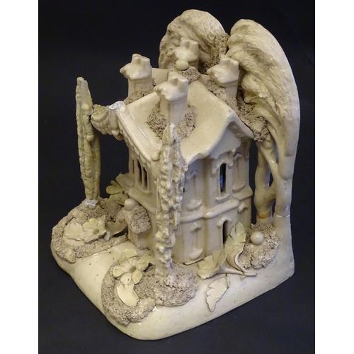 81 - A large Victorian Staffordshire creamware pastille burner modelled as a house and garden with trees.... 