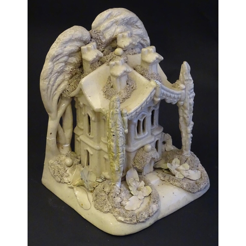 81 - A large Victorian Staffordshire creamware pastille burner modelled as a house and garden with trees.... 