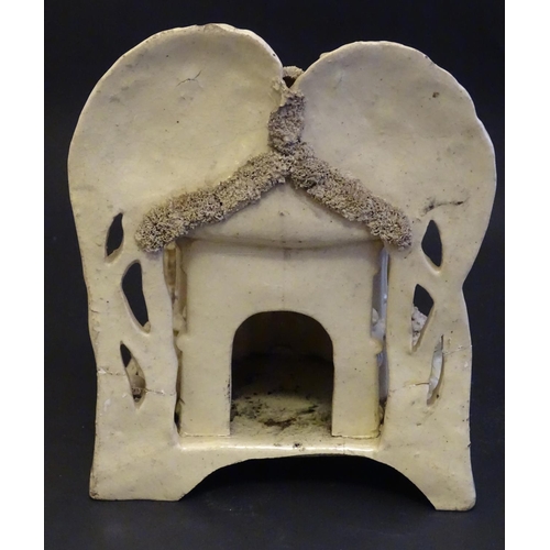 81 - A large Victorian Staffordshire creamware pastille burner modelled as a house and garden with trees.... 