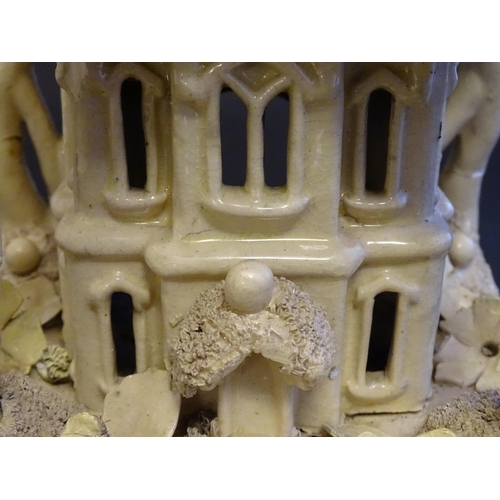 81 - A large Victorian Staffordshire creamware pastille burner modelled as a house and garden with trees.... 