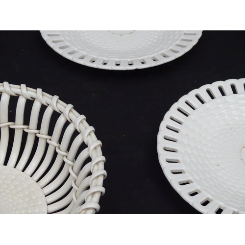 82 - A quantity of Continental creamware chestnut baskets, plates and dishes with reticulated detail. Wit... 