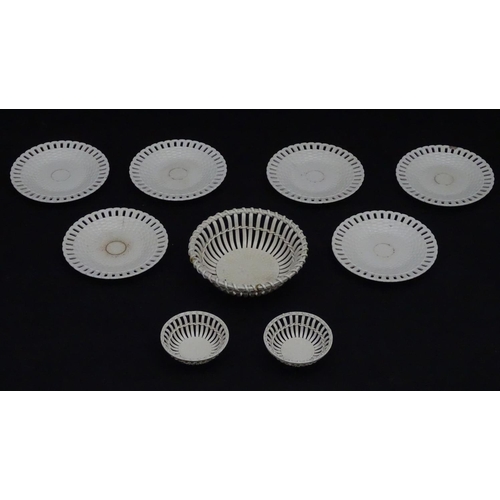 82 - A quantity of Continental creamware chestnut baskets, plates and dishes with reticulated detail. Wit... 