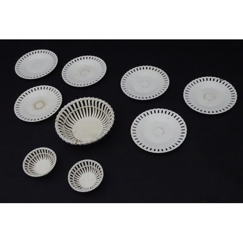 82 - A quantity of Continental creamware chestnut baskets, plates and dishes with reticulated detail. Wit... 