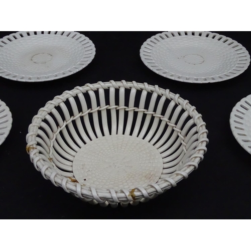 82 - A quantity of Continental creamware chestnut baskets, plates and dishes with reticulated detail. Wit... 